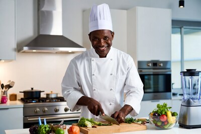 African-American chef chopping vegetables
