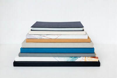 Stack of colorful books on white background