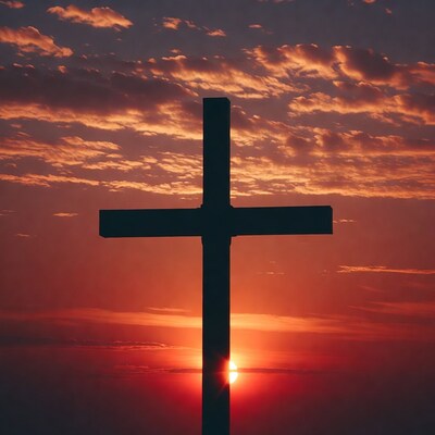 Silhouette cross at sunset