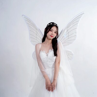 Asian woman in white fairy wings dress