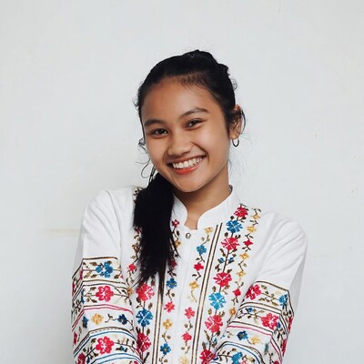 Smiling Asian girl in embroidered white dress