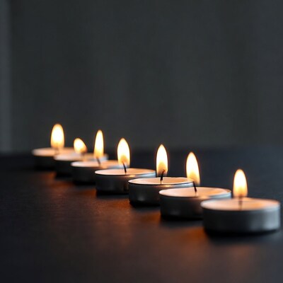 Row of lit tea light candles