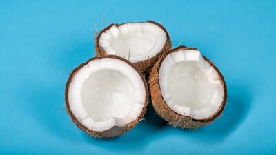 Three split coconuts on blue background
