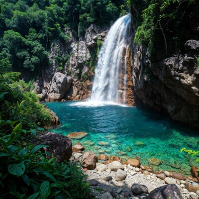 Waterfall cascading into turquoise pool