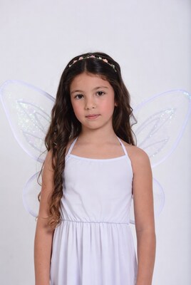 Girl in white fairy costume with wings