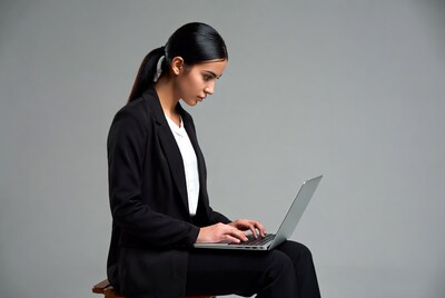Asian woman typing on laptop