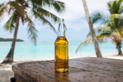 Beer bottle on table with beach background