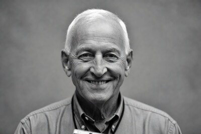 Smiling elderly man with name badge