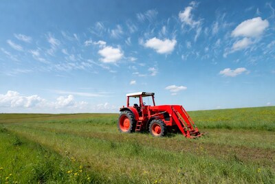 Red tractor in green field