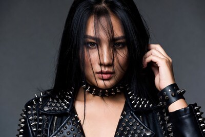 Asian woman in spiked leather jacket