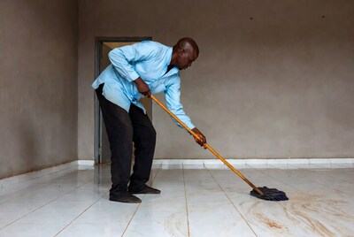 African man mopping floor