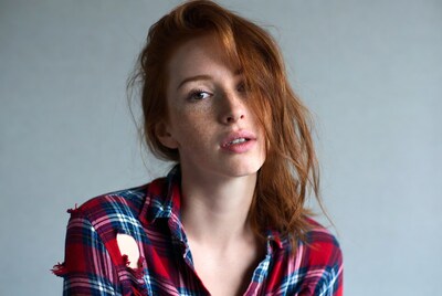 Redhead woman in plaid shirt