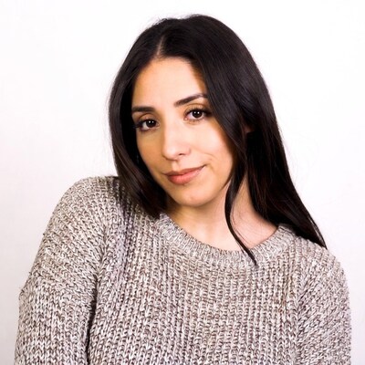 Smiling Latina woman in gray sweater
