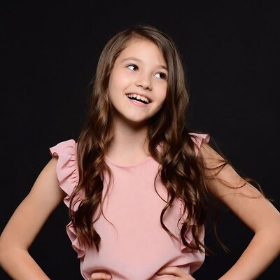 Smiling girl in pink ruffle dress
