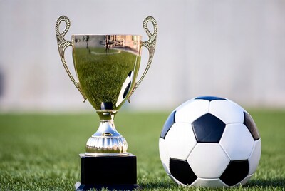 Gold Trophy and Soccer Ball on Grass