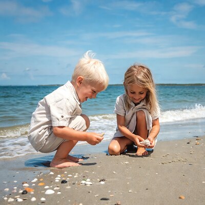 Blonde boy and girl finding seashells on beach