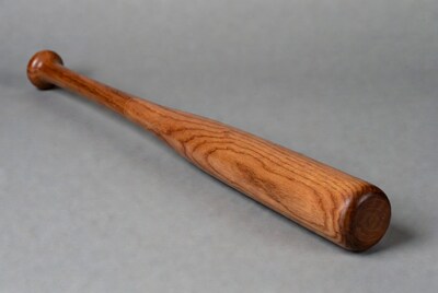 Wooden baseball bat on gray background