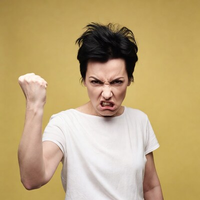 Woman with clenched fist angry expression