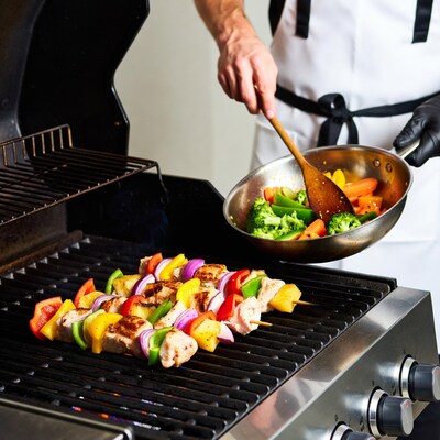 Chef grilling vegetable chicken skewers