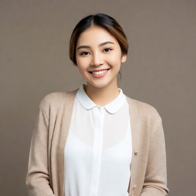 Asian woman smiling in beige cardigan