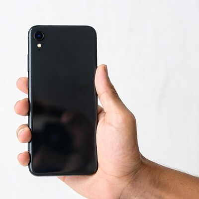 Hand holding black iPhone XR