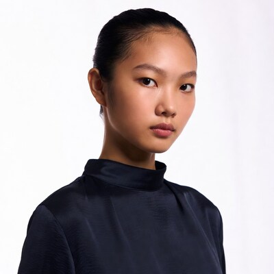 Asian woman in black turtleneck