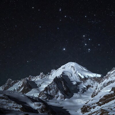 Snowy Mountains Under Starry Night Sky