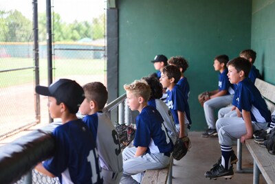 Boys baseball team on dugout bench