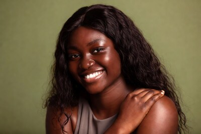 Smiling African-American woman on green background