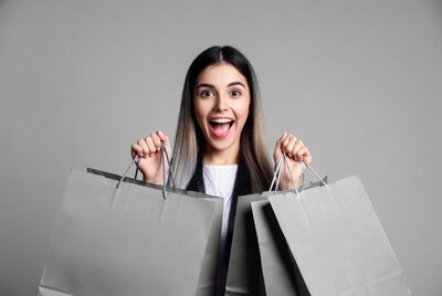 Excited woman holding shopping bags