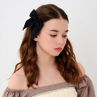 Girl with black bow in brown hair