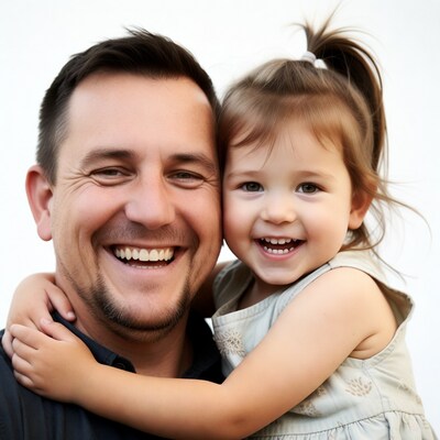 Father hugging smiling toddler daughter