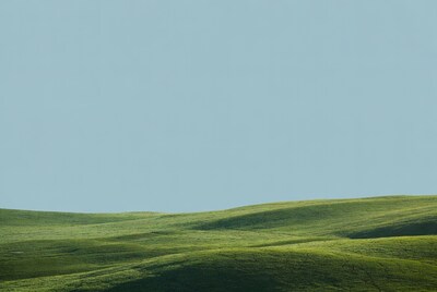 Rolling Green Hills Under Blue Sky