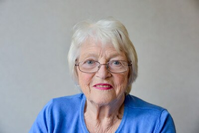 Elderly woman with glasses smiling