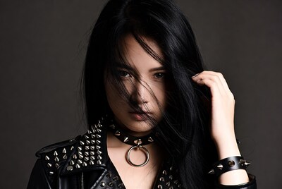 Asian woman in spiked leather jacket