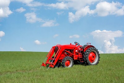 Red tractor in green field