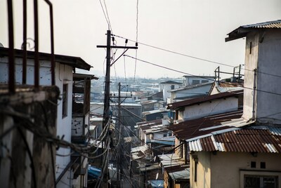 Slum rooftops with tangled power lines