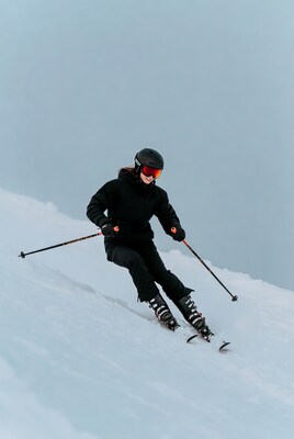 Woman skiing down snowy slope