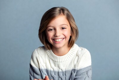 Smiling girl in white sweater