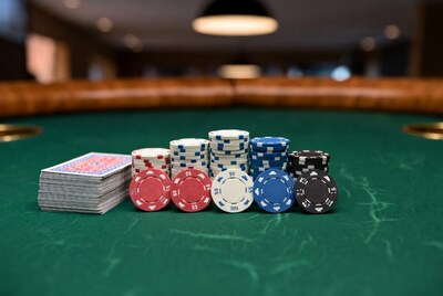 Poker chips and cards on green table