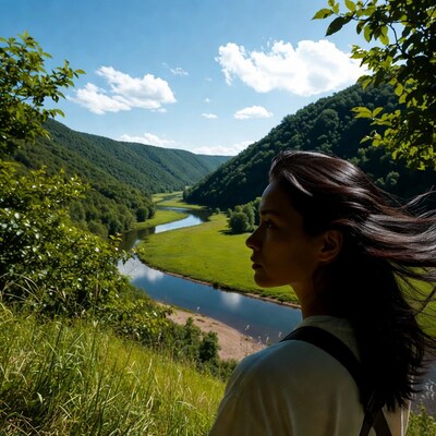 Asian woman overlooking river valley