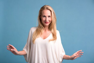 Blonde woman with arms outstretched