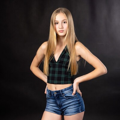 Blonde girl in plaid top and denim shorts