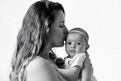 Mother kissing baby on cheek