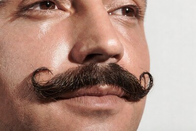 Man with curly mustache close-up