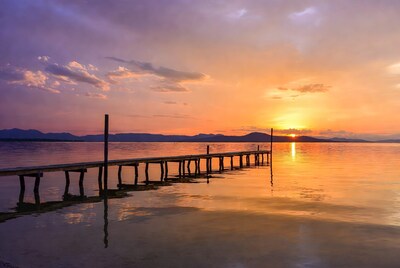 Wooden pier at sunset over lake