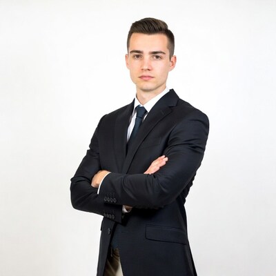 Young man in suit arms crossed