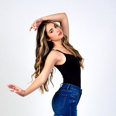Young woman posing in black top jeans
