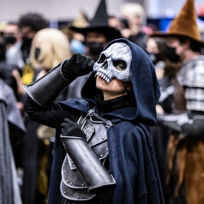 Woman in skull mask cosplay at convention