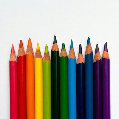 Rainbow colored pencils on white